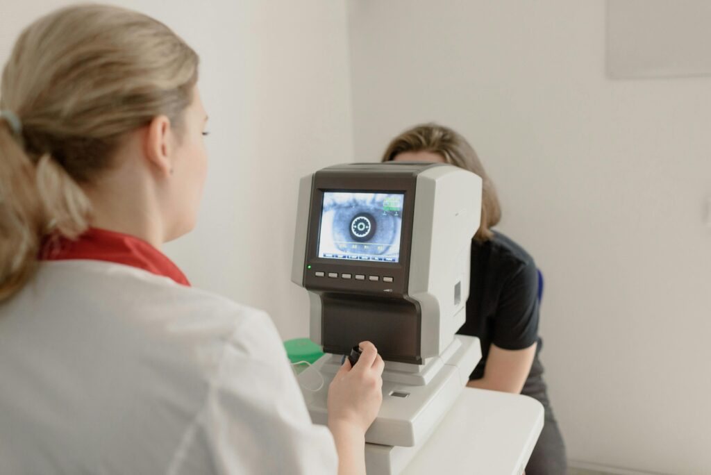 Ophthalmologist performing an eye examination using a digital diagnostic machine.